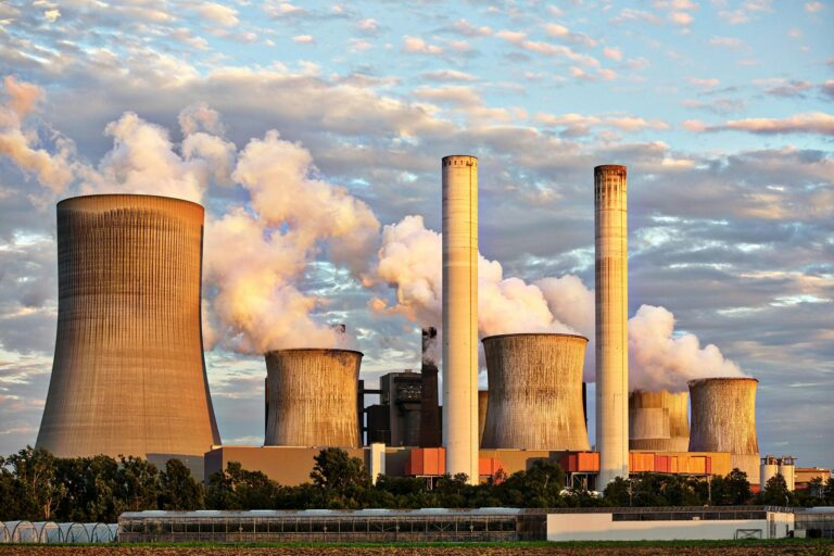 a large factory with smoke stacks